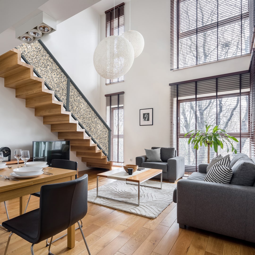 Photo of entryway wooden stairs that feature a Feeney aluminum laser-cut panel infill.