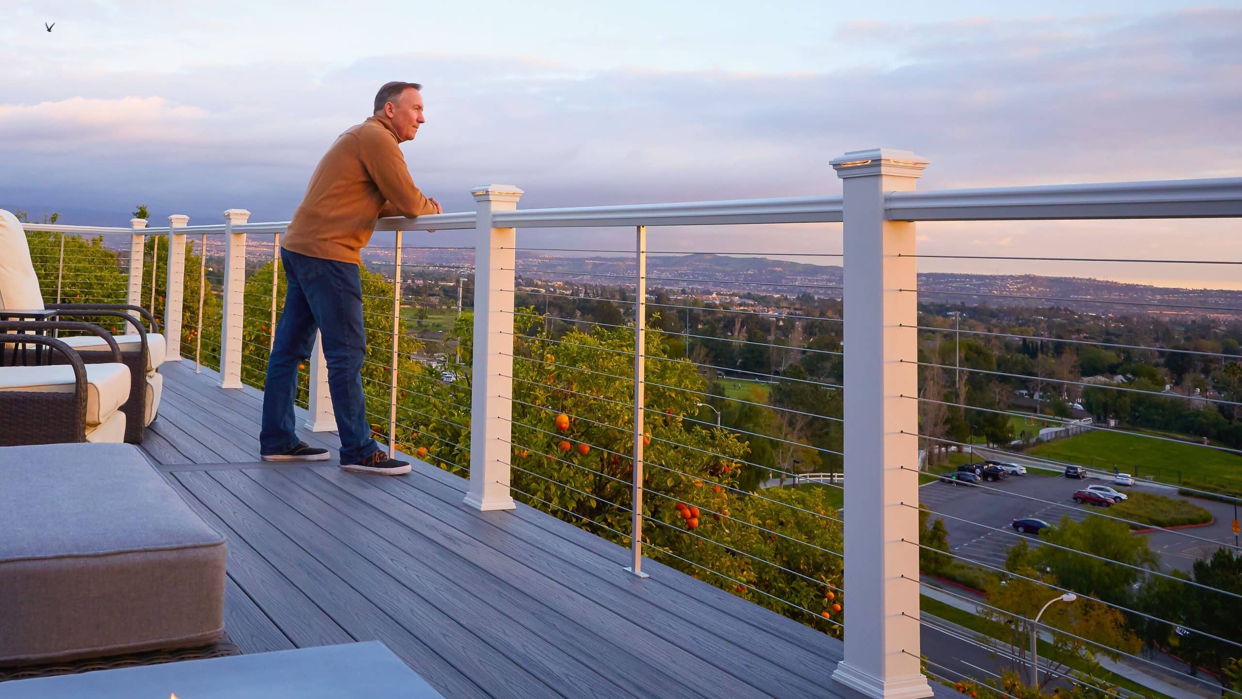 cable railing deck of home person looking out at city