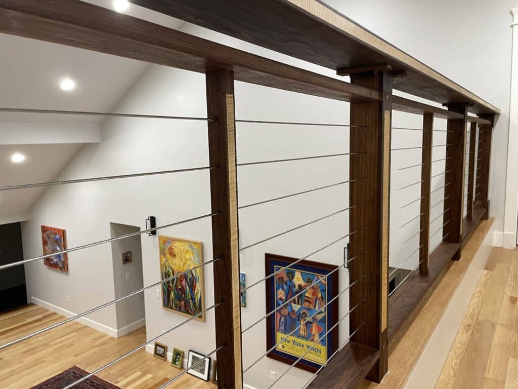 Exquisite Craftsmanship utilzing wood components of walnut, flame maple, quilted sapele and rosewood. CableRail virtually disappears in this beautiful interior space in Groton, MA.